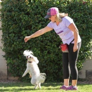 Kristie, positive reinforcement dog trainer in Glendale, AZ, teaching her dog Stella how to dance.