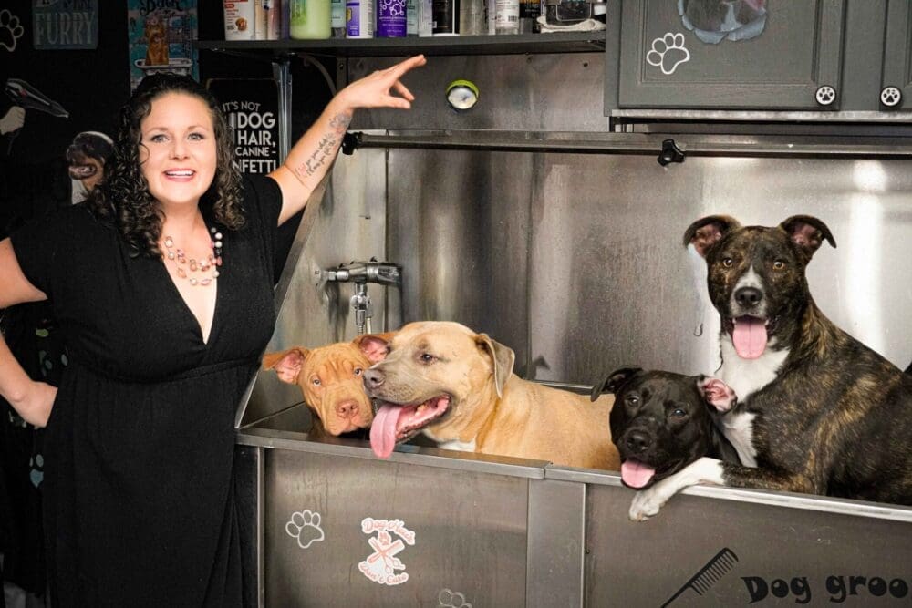 Kristie Halverson, owner & Positive Dog Trainer at FurBabies & Friends and her 4 bully mixes in dog grooming bath tub.